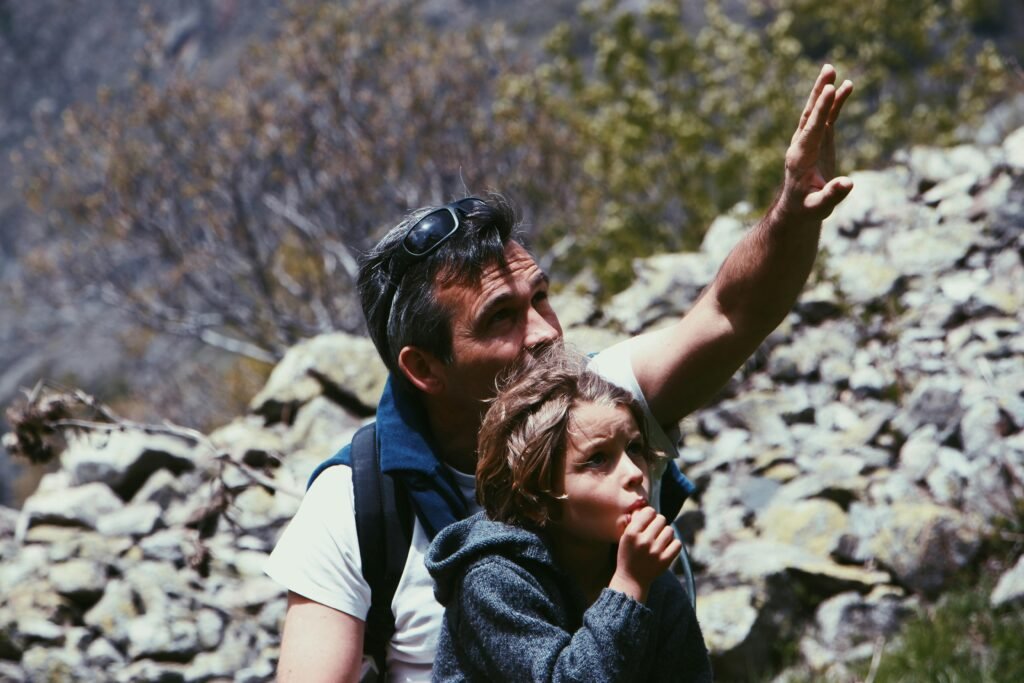 Father and child enjoying an adventurous hike in Champoléon, Provence-Alpes-Côte d'Azur.