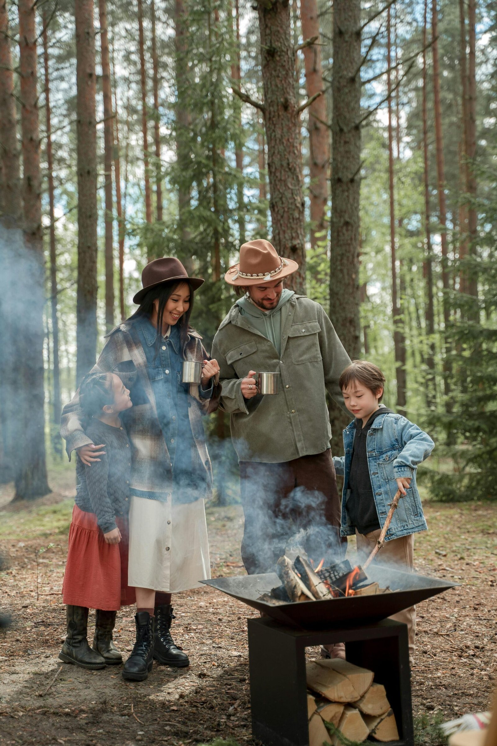 A family bonding around a cozy campfire in a serene woodland setting.