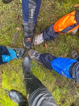 Five hikers in boots converging on mossy ground in Gilan Province, Iran.