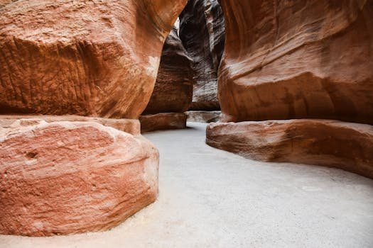 Explore the awe-inspiring red rock canyon passage of Petra, an iconic Jordanian treasure.