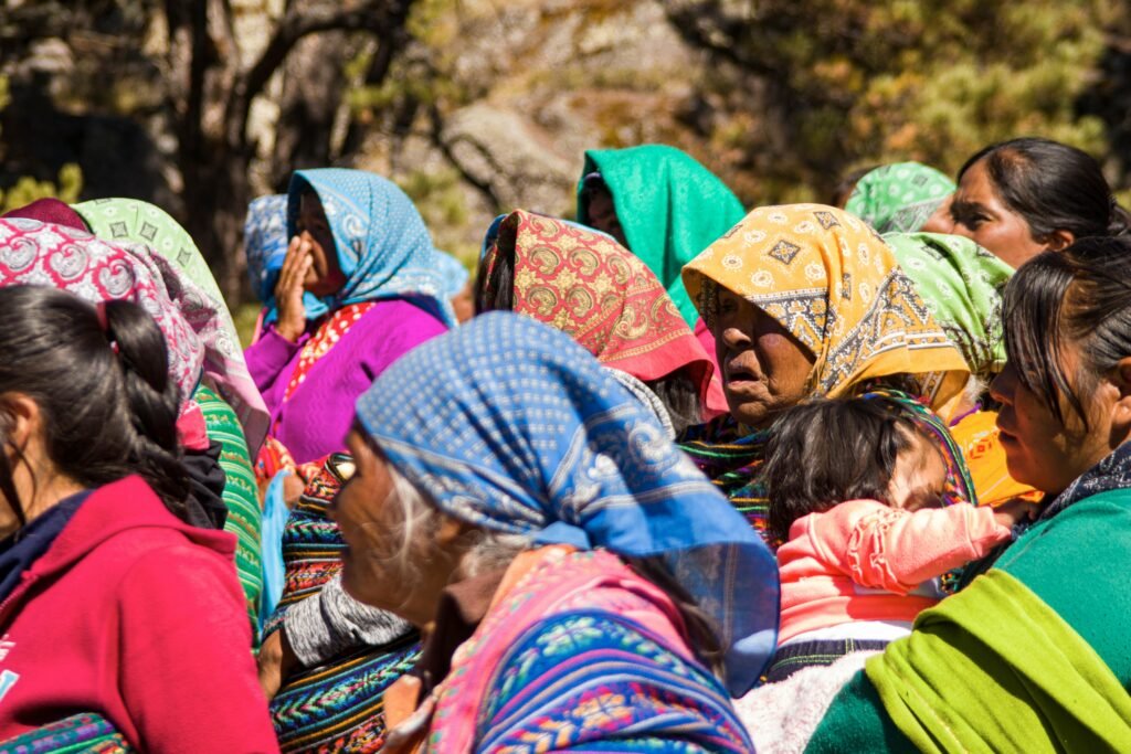 A colorful gathering of Indigenous women in traditional attire, showcasing cultural diversity.