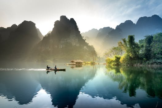 Tranquil lake with mountains reflecting at sunrise in Tuyên Quang, Vietnam.