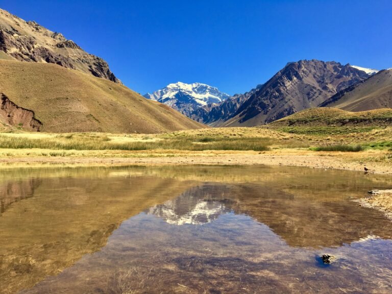 A stunning view of Aconcagua reflecting in a tranquil lake in Mendoza, Argentina.