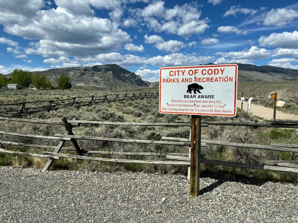 Explore City of Cody's natural landscape with bear awareness signage.
