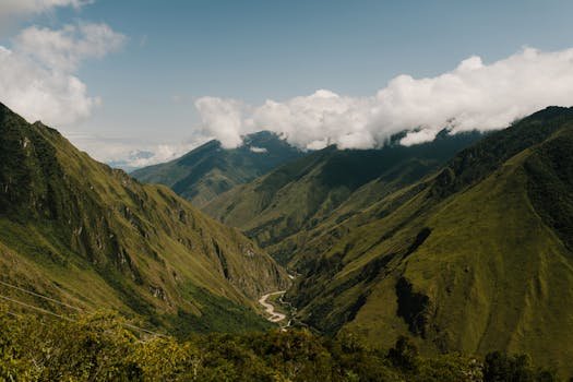 Breathtaking view of the Andes mountains in Peru under a blue sky with white clouds.